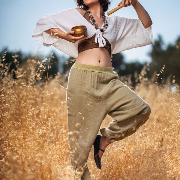 Woman performing a calm yoga pose in a bright, serene environment.